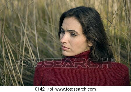 portrait of pensive looking woman lying in field View Large Photo Image Stock Image - portrait of pensive looking woman lying in field. Fotosearch