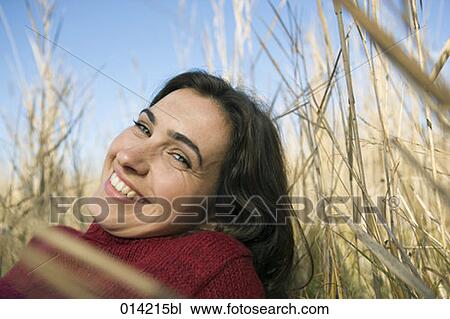 portrait of smiling woman lying in reeds View Large Photo Image Stock Image - portrait of smiling woman lying in reeds. Fotosearch