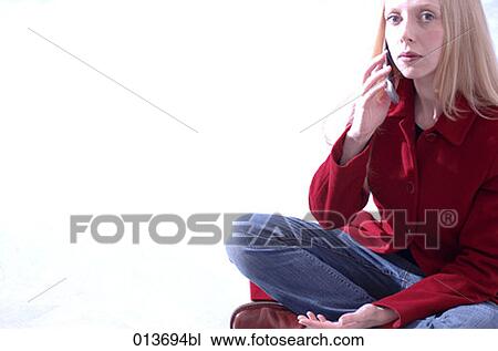 portrait of woman sitting using cellular phone View Large Photo Image Stock Image - portrait of woman sitting using cellular phone. Fotosearch