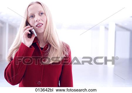 Stock Image - portrait of young businesswoman listening to her mobile phone. Fotosearch