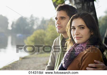 portrait of young couple sitting together woman looking at camera View Large Photo Image Stock Image - portrait of young couple sitting together woman looking at camera. Fotosearch