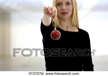 portrait of young woman holding bauble View Large Photo Image Stock Image - portrait of young woman holding bauble. Fotosearch