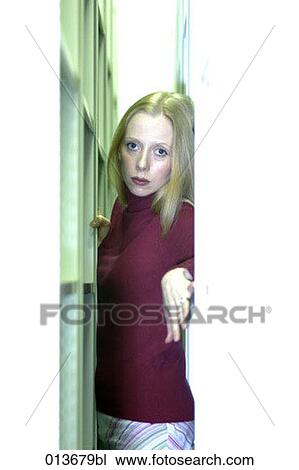 portrait of young woman jammed between shelves View Large Photo Image Stock Image - portrait of young woman jammed between shelves. Fotosearch