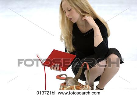 portrait of young woman kneeling having a look in her journal View Large Photo Image Stock Image - portrait of young woman kneeling having a look in her journal. Fotosearch