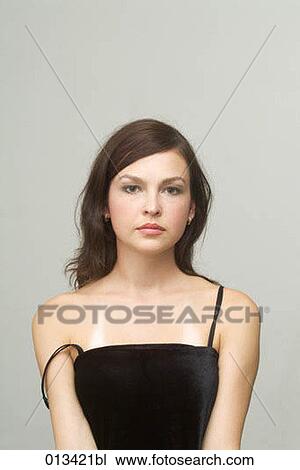 Stock Image - portrait of young woman wearing black dress. Fotosearch
