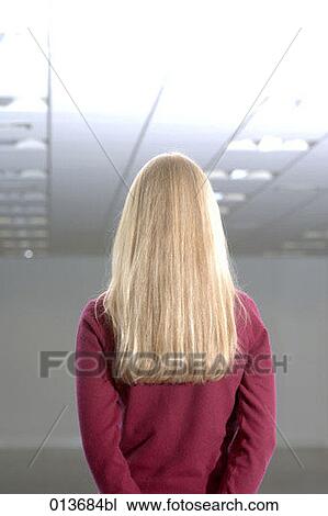 rear view of blond woman standing in empty office space View Large Photo Image Stock Image - rear view of blond woman standing in empty office space. Fotosearch