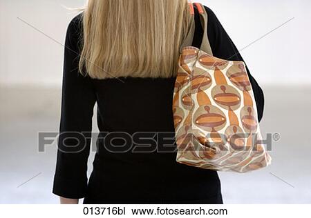 rear view of blond woman with handbag over shoulder View Large Photo Image Stock Image - rear view of blond woman with handbag over shoulder. Fotosearch
