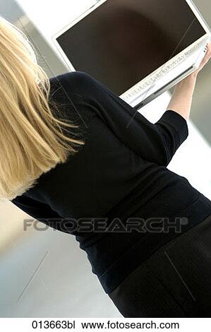rear view of woman carrying notebook computer View Large Photo Image Stock Image - rear view of woman carrying notebook computer. Fotosearch
