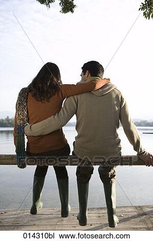 rear view of young couple sitting together in autumn View Large Photo Image Stock Image - rear view of young couple sitting together in autumn. Fotosearch