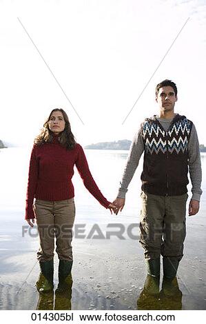 serious looking couple standing in lake View Large Photo Image Stock Image - serious looking couple standing in lake. Fotosearch