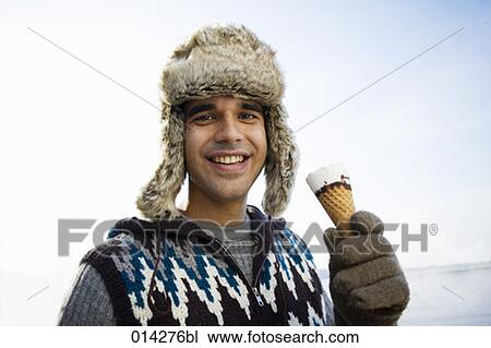 smiling man with fur hat having an ice cream View Large Photo Image Stock Image - smiling man with fur hat having an ice cream. Fotosearch