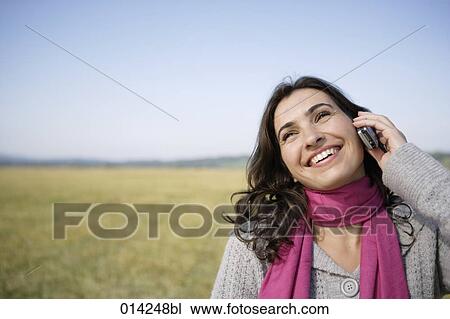 smiling woman having phone conversation with her mobile View Large Photo Image Stock Image - smiling woman having phone conversation with her mobile. Fotosearch