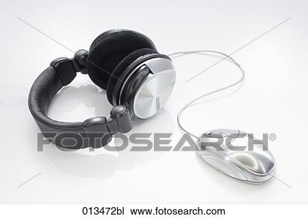 Stock Image - still life of earphones and computer mouse. Fotosearch