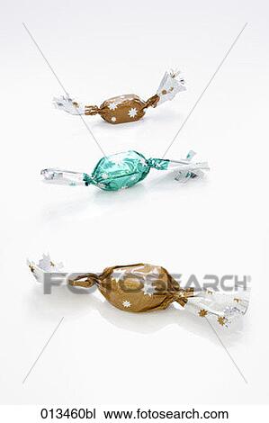 still life of three wrapped candies one blue two brown View Large Photo Image Stock Image - still life of three wrapped candies one blue two brown. Fotosearch