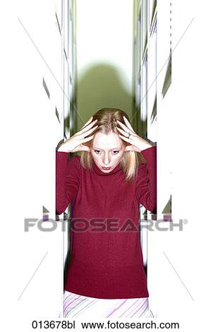 stressed young woman standing between shelves View Large Photo Image Stock Image - stressed young woman standing between shelves. Fotosearch