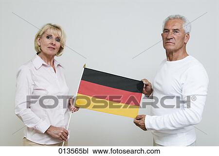 two mature people holding German flag View Large Photo Image Stock Image - two mature people holding German flag. Fotosearch