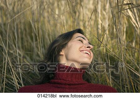 woman happily laughing in field View Large Photo Image Stock Image - woman happily laughing in field. Fotosearch