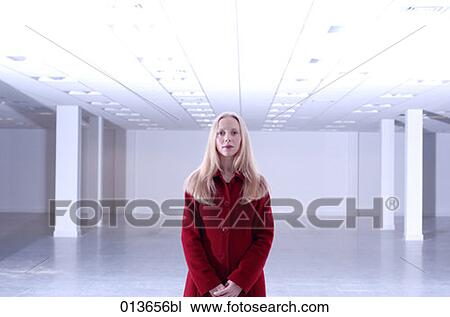 woman in red coat standing in empty office space View Large Photo Image Stock Image - woman in red coat standing in empty office space. Fotosearch