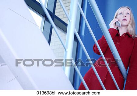 woman in red coat standing staircase talking on mobile phone View Large Photo Image Stock Image - woman in red coat standing staircase talking on mobile phone . Fotosearch