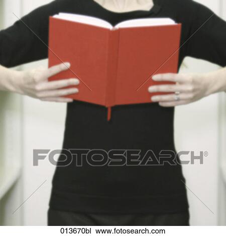 Stock Image - woman reading red book. Fotosearch