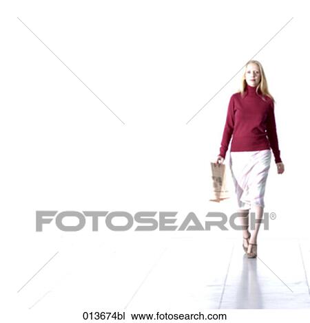 young businesswoman walking with newspaper in hand View Large Photo Image Stock Image - young businesswoman walking with newspaper in hand. Fotosearch