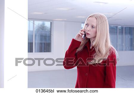 young businesswoman with mobile in empty office space View Large Photo Image Stock Image - young businesswoman with mobile in empty office space. Fotosearch