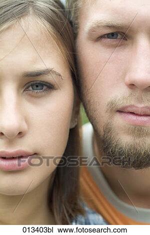 Stock Image - young couple cheek to cheek. Fotosearch