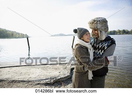 young couple having a laugh in winter at lakeside View Large Photo Image Stock Image - young couple having a laugh in winter at lakeside. Fotosearch