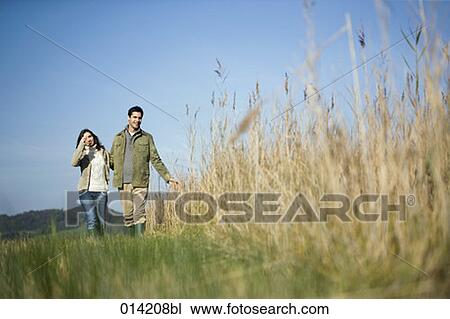young couple having a walk in autumn View Large Photo Image Stock Image - young couple having a walk in autumn. Fotosearch