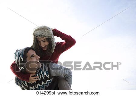 young couple having fun man giving piggyback ride to woman View Large Photo Image Stock Image - young couple having fun man giving piggyback ride to woman. Fotosearch