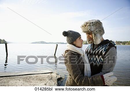 young couple standing at lake lovingly looking at each other View Large Photo Image Stock Image - young couple standing at lake lovingly looking at each other. Fotosearch