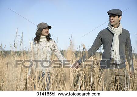 young couple standing in field with doubtful expressions View Large Photo Image Stock Image - young couple standing in field with doubtful expressions. Fotosearch