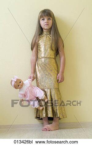 young girl in golden dress holding puppet View Large Photo Image Stock Image - young girl in golden dress holding puppet. Fotosearch