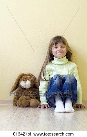 young girl sitting on floor with cuddly toy View Large Photo Image Stock Image - young girl sitting on floor with cuddly toy. Fotosearch