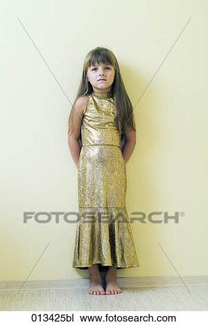 young girl standing against wall with serious expression View Large Photo Image Stock Image - young girl standing against wall with serious expression. Fotosearch
