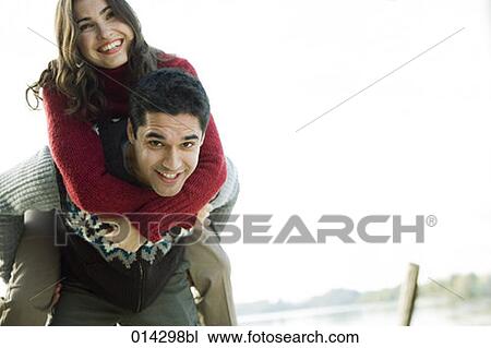 young man giving woman a piggyback ride View Large Photo Image Stock Image - young man giving woman a piggyback ride. Fotosearch