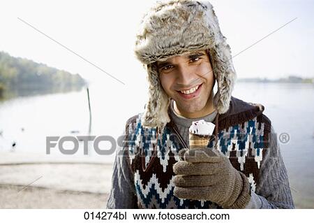 young man in winter clothes holding ice View Large Photo Image Stock Image - young man in winter clothes holding ice. Fotosearch
