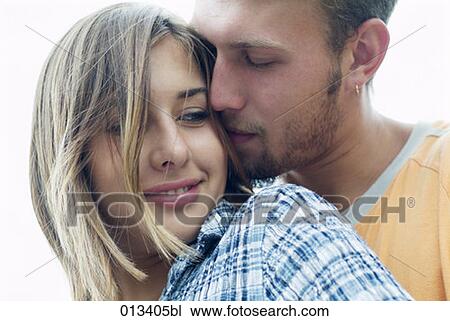 young woman being embraced by boyfriend View Large Photo Image Stock Image - young woman being embraced by boyfriend. Fotosearch
