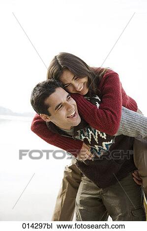 young woman enjoying piggyback ride View Large Photo Image Stock Image - young woman enjoying piggyback ride. Fotosearch