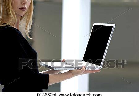 young woman holding laptop computer View Large Photo Image Stock Image - young woman holding laptop computer. Fotosearch