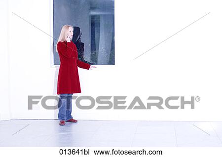 young woman in empty space talking on mobile View Large Photo Image Stock Image - young woman in empty space talking on mobile. Fotosearch
