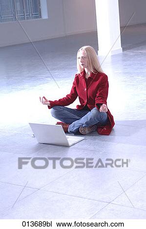 young woman sitting in empty office meditating View Large Photo Image Stock Image - young woman sitting in empty office meditating. Fotosearch
