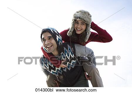 young woman with fur hat enjoying piggyback ride View Large Photo Image Stock Image - young woman with fur hat enjoying piggyback ride. Fotosearch