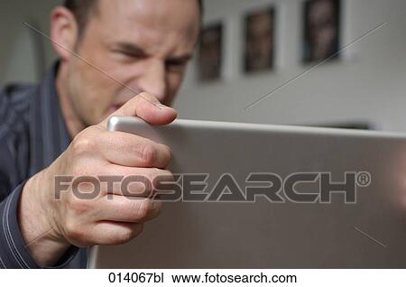 Stock Image - angry man with laptop computer. Fotosearch