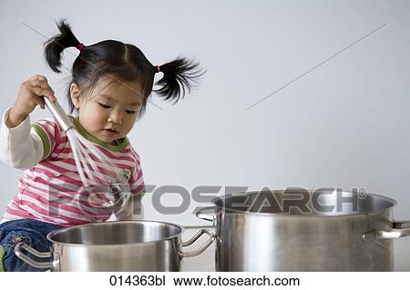 asian baby playing with eggbeater and saucepans View Large Photo Image Stock Image - asian baby playing with eggbeater and saucepans. Fotosearch