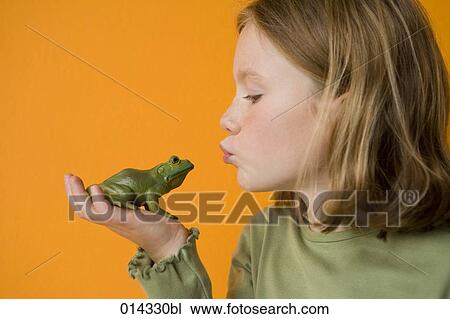 blond girl kissing toy frog to make a wish View Large Photo Image Stock Image - blond girl kissing toy frog to make a wish. Fotosearch