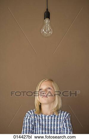 blonde boy looking at bare light bulb View Large Photo Image Stock Image - blonde boy looking at bare light bulb. Fotosearch