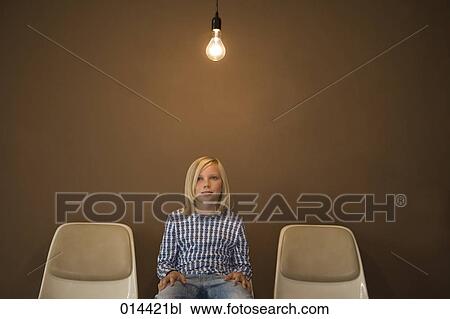 blonde boy sitting on chair under light bulb View Large Photo Image Stock Image - blonde boy sitting on chair under light bulb. Fotosearch
