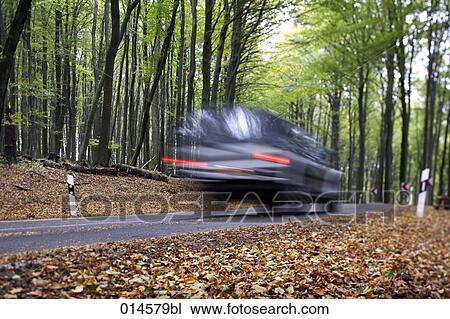 blurred image of car driving down road in autumn View Large Photo Image Stock Image - blurred image of car driving down road in autumn. Fotosearch