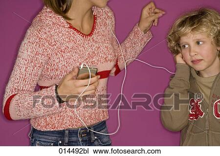 boy listening to mp3 music while sister is dancing View Large Photo Image Stock Image - boy listening to mp3 music while sister is dancing. Fotosearch